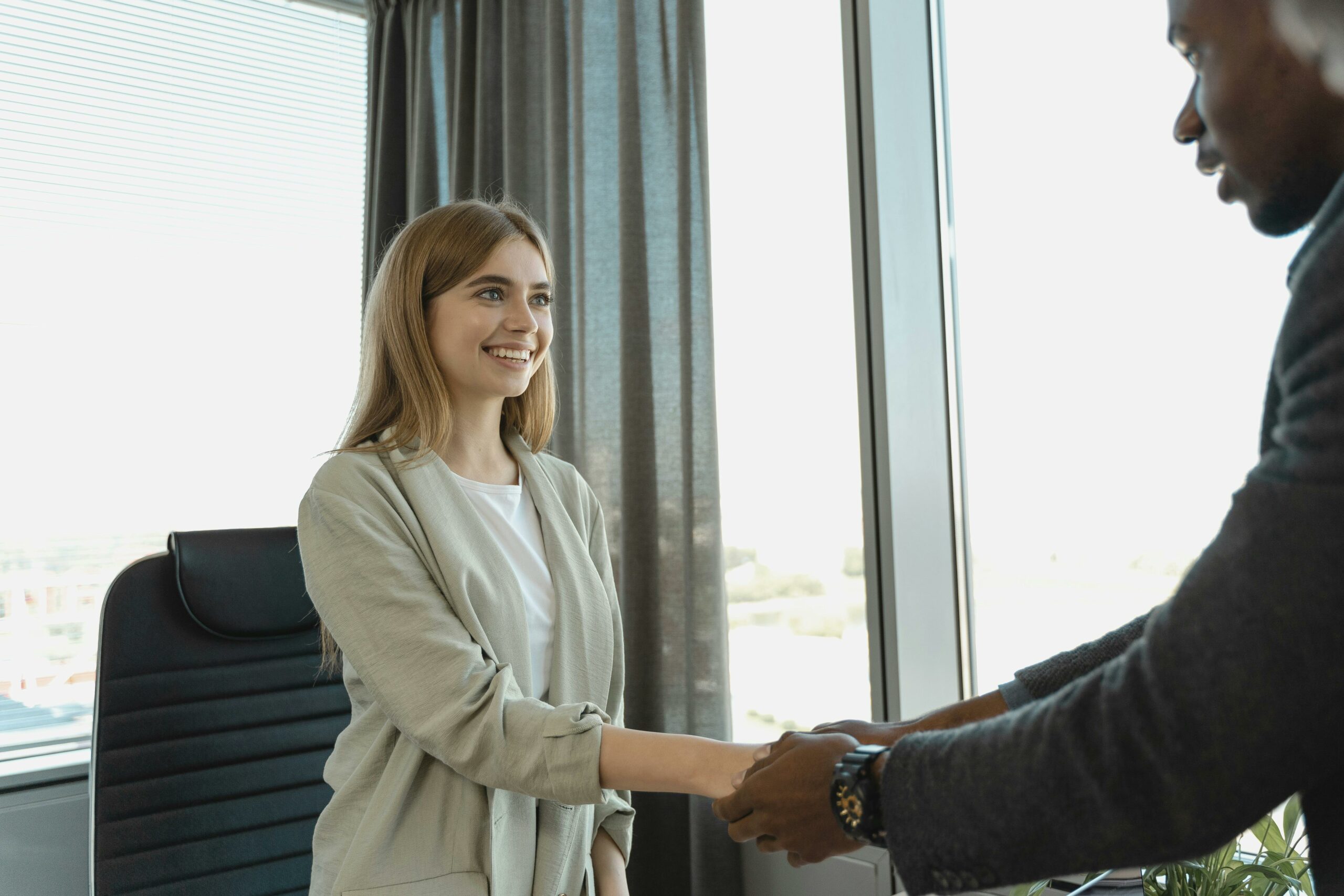 A woman making a first impression shaking a guys hand.