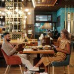 A man and woman having dinner facing each other. She is thinking How to Know If He Is Interested in You