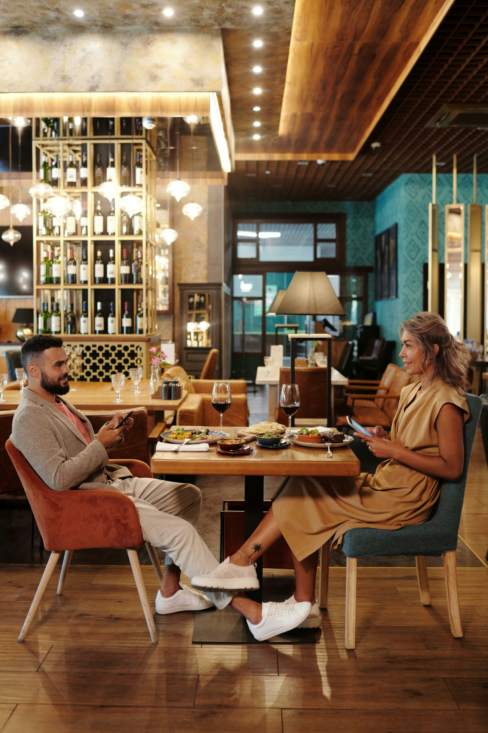 A man and woman having dinner facing each other. She is thinking How to Know If He Is Interested in You