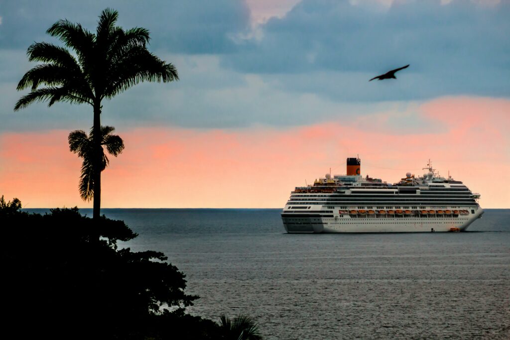 A picture of a cruise ship at sea with pictures of palm trees in the forefront. How to Plan the Ultimate Romantic Getaway