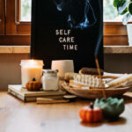 Self-care, Wellness in autumn, winter cold season. Letter board text Self Care Time, aroma sticks, body and self-care handmade cosmetics and beauty product and decor pumpkins.