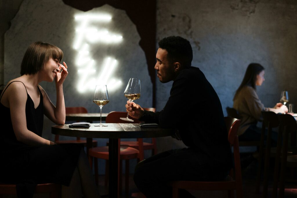 a couple talking over a glass of wine.