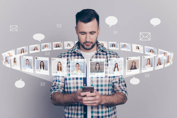 Close up portrait serious successful he his him hold look telephone typing sms different ladies pictures illustration global search innovation microblogging isolated grey background. Online vs. In Person Dating