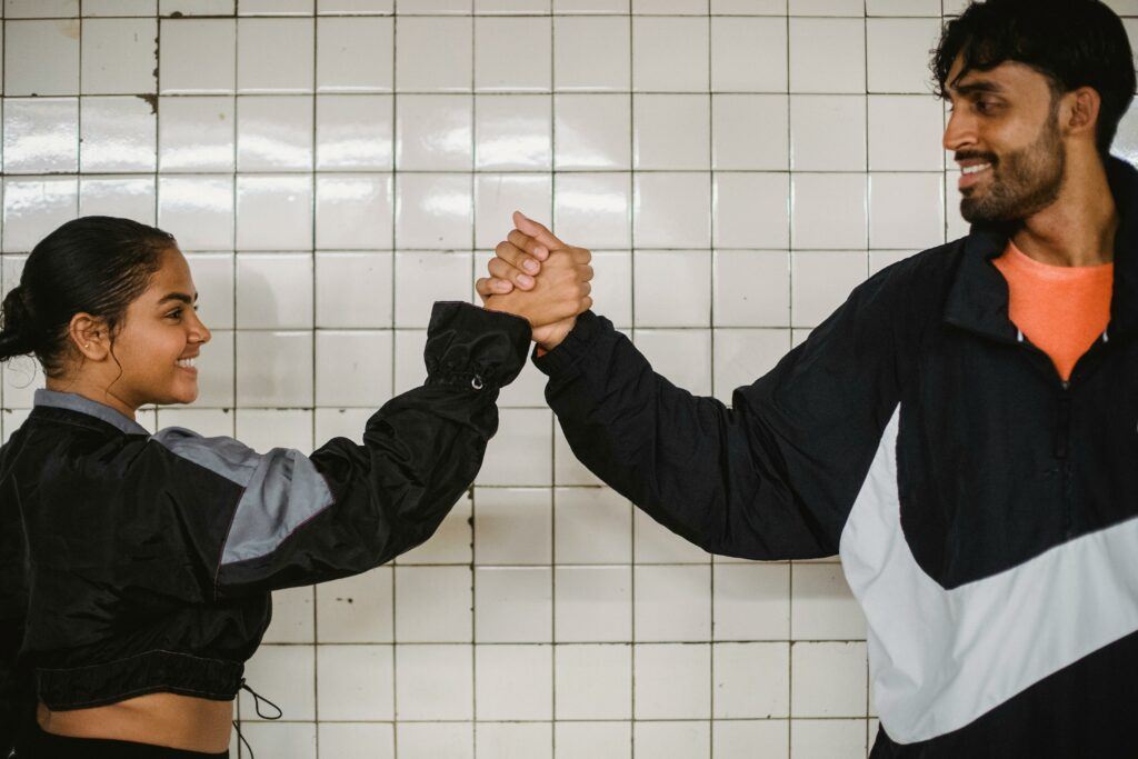 a couple high fiving because they have shared goals. Best Marriage Advice for Newlyweds